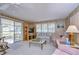 Living room with wood paneling, couches, and a TV at 6125 Alpine Dr, Zephyrhills, FL 33542