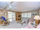 Living room with rocking chair and access to screened porch at 6125 Alpine Dr, Zephyrhills, FL 33542