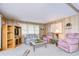 Living room featuring floral couches and a wood cabinet at 6125 Alpine Dr, Zephyrhills, FL 33542