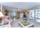 Living room with rocking chair and view into dining area at 6125 Alpine Dr, Zephyrhills, FL 33542