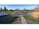 Backyard with pond view and a walkway leading to a fenced area at 6411 Monterey Blvd, Tampa, FL 33625