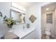 Modern bathroom with white tile, quartz vanity, and elegant mirror at 6411 Monterey Blvd, Tampa, FL 33625