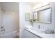 Clean bathroom with white subway tile, a vanity with a quartz countertop and a bathtub at 6411 Monterey Blvd, Tampa, FL 33625