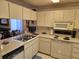 Kitchen with white cabinets and electric range at 6428 Remus Dr, New Port Richey, FL 34653