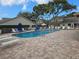 Community pool with lounge chairs and brick patio at 6428 Remus Dr, New Port Richey, FL 34653