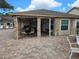 Covered patio area with tables and chairs near pool at 6428 Remus Dr, New Port Richey, FL 34653