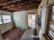 View of a dilapidated kitchen with exposed beams and damaged walls at 6502 S Himes Ave, Tampa, FL 33611