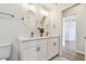 Modern bathroom with double vanity, white cabinets, and a decorative mirror at 714 Hidden Lake Dr, Tarpon Springs, FL 34689