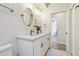 Modern bathroom with double vanity, white cabinets, and a decorative mirror at 714 Hidden Lake Dr, Tarpon Springs, FL 34689