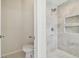 Small bathroom with toilet and shower at 714 Hidden Lake Dr, Tarpon Springs, FL 34689