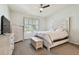 Bedroom with a queen bed, dresser, and large window at 714 Hidden Lake Dr, Tarpon Springs, FL 34689