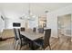 Modern dining room with six chairs and a view into the kitchen at 714 Hidden Lake Dr, Tarpon Springs, FL 34689