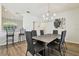 Elegant dining room with a large table, six chairs, and a modern chandelier at 714 Hidden Lake Dr, Tarpon Springs, FL 34689