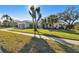 House exterior in sunlight, showcasing landscaping and garage at 714 Hidden Lake Dr, Tarpon Springs, FL 34689