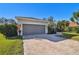 House exterior showcasing landscaping and garage at 714 Hidden Lake Dr, Tarpon Springs, FL 34689