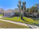 House exterior showcasing a well maintained lawn and driveway at 714 Hidden Lake Dr, Tarpon Springs, FL 34689