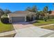 Single-Gathering home exterior with a gray garage door at 714 Hidden Lake Dr, Tarpon Springs, FL 34689