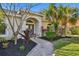 Attractive landscaping surrounds the walkway to the front entrance at 714 Hidden Lake Dr, Tarpon Springs, FL 34689