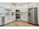 Modern kitchen with stainless steel appliances and white shaker cabinets at 714 Hidden Lake Dr, Tarpon Springs, FL 34689