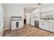 Modern kitchen featuring white cabinets, stainless steel appliances, and luxury vinyl plank flooring at 714 Hidden Lake Dr, Tarpon Springs, FL 34689