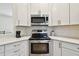 Modern kitchen with stainless steel appliances and white cabinets at 714 Hidden Lake Dr, Tarpon Springs, FL 34689