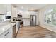 Modern kitchen with stainless steel appliances and white cabinets at 714 Hidden Lake Dr, Tarpon Springs, FL 34689