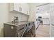 Laundry room with LG washer and dryer, upper cabinets, and a view of the kitchen at 714 Hidden Lake Dr, Tarpon Springs, FL 34689