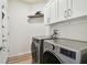 Laundry room with LG washer and dryer, upper cabinets, and wood-look flooring at 714 Hidden Lake Dr, Tarpon Springs, FL 34689