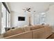 Bright living room featuring a sectional sofa, large TV, and sliding glass doors at 714 Hidden Lake Dr, Tarpon Springs, FL 34689