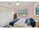 Bedroom with pink walls, ceiling fan, and window at 731 74Th N St, St Petersburg, FL 33710