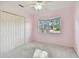 Light pink bedroom with ceiling fan and carpet at 731 74Th N St, St Petersburg, FL 33710