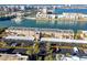 Aerial view of waterfront condo building with parking and tropical landscaping at 7540 Bay Island S Dr # 253, South Pasadena, FL 33707