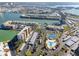 Aerial view of waterfront community with tennis courts, pool, and parking at 7540 Bay Island S Dr # 253, South Pasadena, FL 33707