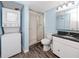 Bathroom with shower, toilet and stackable washer/dryer at 7540 Bay Island S Dr # 253, South Pasadena, FL 33707