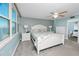 Bright bedroom with water view, ceiling fan, and white bed frame at 7540 Bay Island S Dr # 253, South Pasadena, FL 33707