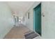 Condo hallway featuring a ramp that leads to a green-painted door with the number 215 at 801 83Rd N Ave # 215, St Petersburg, FL 33702