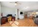 Bright living room featuring wood flooring and a designated workspace, seamlessly connecting living spaces at 801 83Rd N Ave # 215, St Petersburg, FL 33702