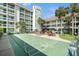 Resort-style living with outdoor shuffleboard court, seating areas, and lush tropical landscaping at 801 83Rd N Ave # 215, St Petersburg, FL 33702