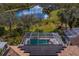 Aerial view showcasing a backyard pool, pond and lush landscaping, creating a peaceful retreat at 8619 Foxtail Ct, Tampa, FL 33647