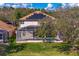 An aerial view of a screened in pool and expansive backyard with solar panels on the roof at 8619 Foxtail Ct, Tampa, FL 33647