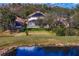 Expansive backyard view showcasing a well-maintained lawn, screened-in pool, and scenic landscaping at 8619 Foxtail Ct, Tampa, FL 33647