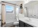 This bathroom has a white tub and shower, a gray vanity and a window at 8619 Foxtail Ct, Tampa, FL 33647