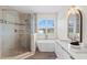 This bathroom features a glass shower, stand alone tub, and a window with natural light at 8619 Foxtail Ct, Tampa, FL 33647