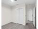 This bedroom has wood flooring, a ceiling fan, a closet and an open doorway at 8619 Foxtail Ct, Tampa, FL 33647