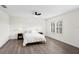 Neutral bedroom featuring a ceiling fan, plantation shutters, and dark bedside tables at 8619 Foxtail Ct, Tampa, FL 33647