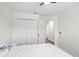 This bedroom has wood flooring, a closet and neutral colors at 8619 Foxtail Ct, Tampa, FL 33647