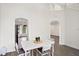 Bright dining area with a modern table set, archways, and hardwood floors at 8619 Foxtail Ct, Tampa, FL 33647