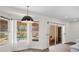 Bright dining room with a pendant light fixture, large windows, and sliding glass door overlooking the pool at 8619 Foxtail Ct, Tampa, FL 33647