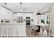 Well-lit kitchen with white cabinets, stainless steel appliances and an island with bar stool seating at 8619 Foxtail Ct, Tampa, FL 33647