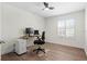 The office features wood flooring, a ceiling fan and a large window allowing in natural light at 8619 Foxtail Ct, Tampa, FL 33647